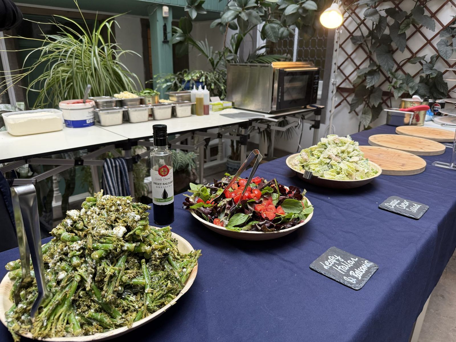 Broccolini and feta, leafy Italian salad and Caesar salad on an indoor buffet