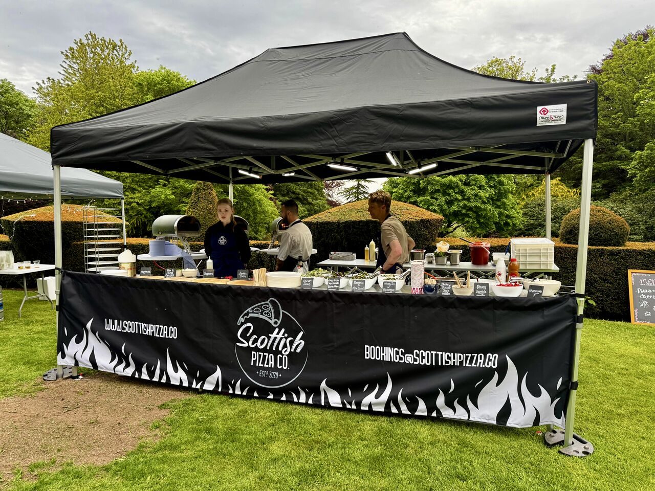 Chefs serving from the Scottish Pizza Co 4.5m outdoor pop-up station