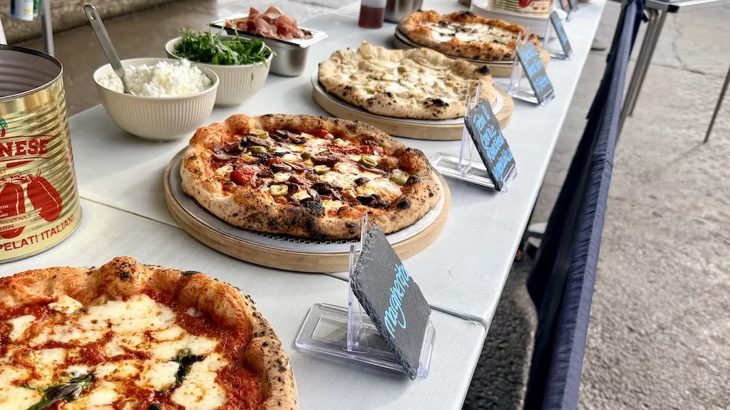 Pizzas on boards with slate name labels at a Scottish Pizza Co pop-up