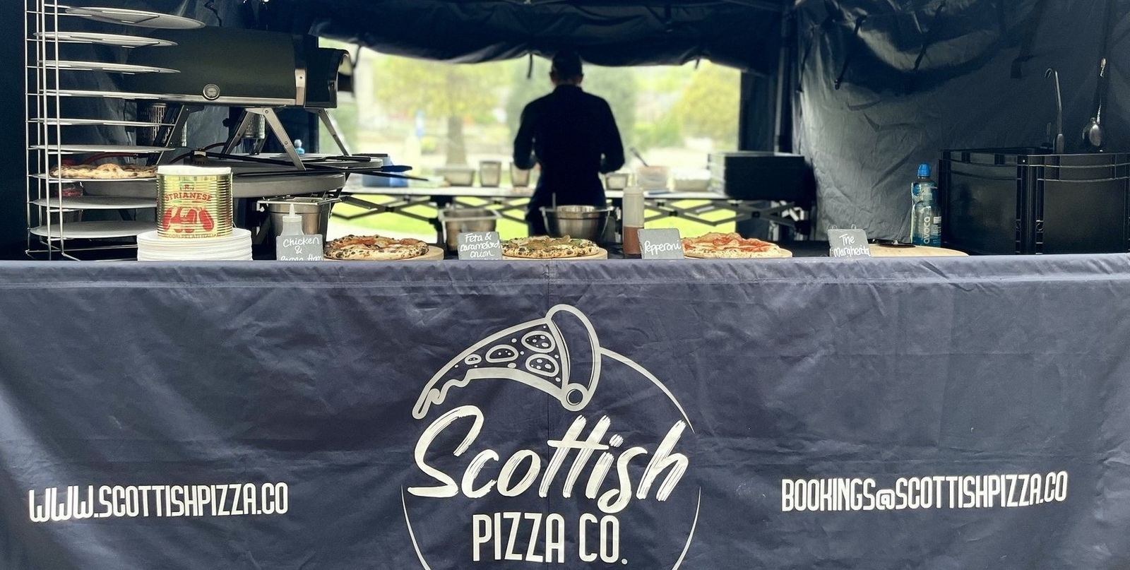 Front of the Scottish Pizza Co pop-up counter with chef at work