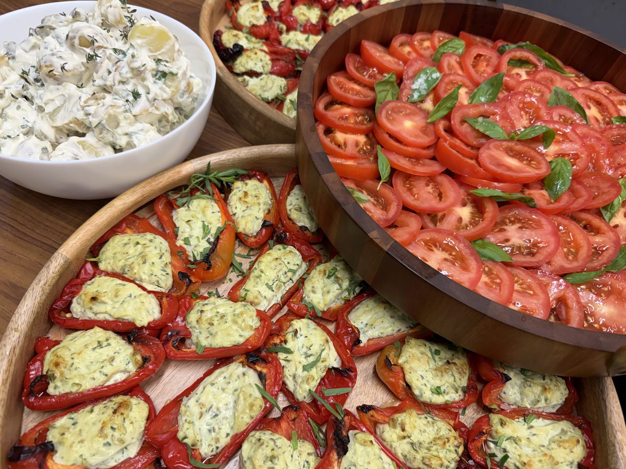 Platters of stuffed roasted peppers and sliced tomato salad on a Scottish Pizza Co wedding buffet