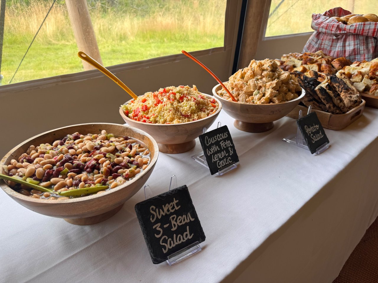 Sweet 3-bean salad and sharing sides with chalkboard labels by the marquee windows